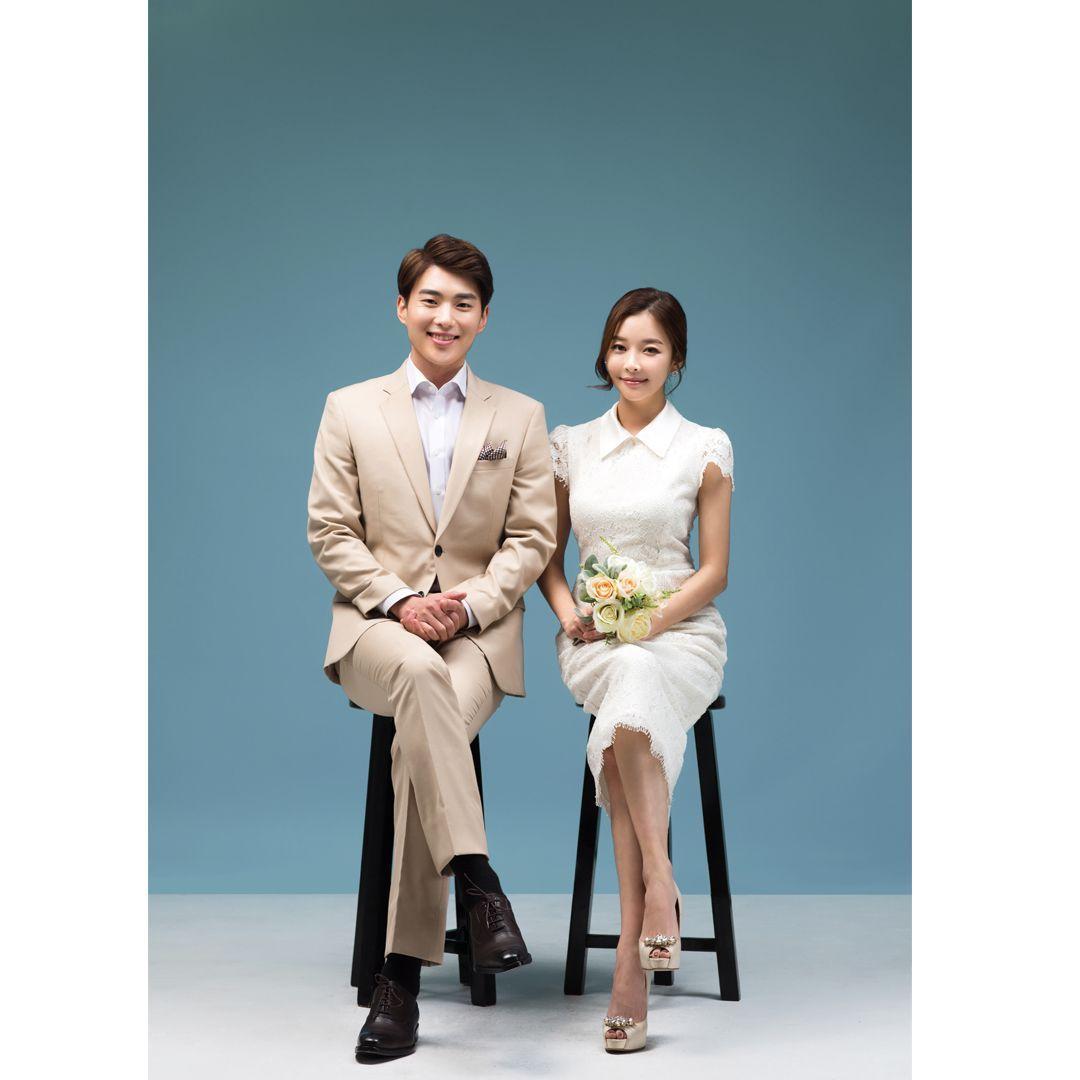 Couple in matching blue outfits, conveying harmony and style in Korean studio photography.