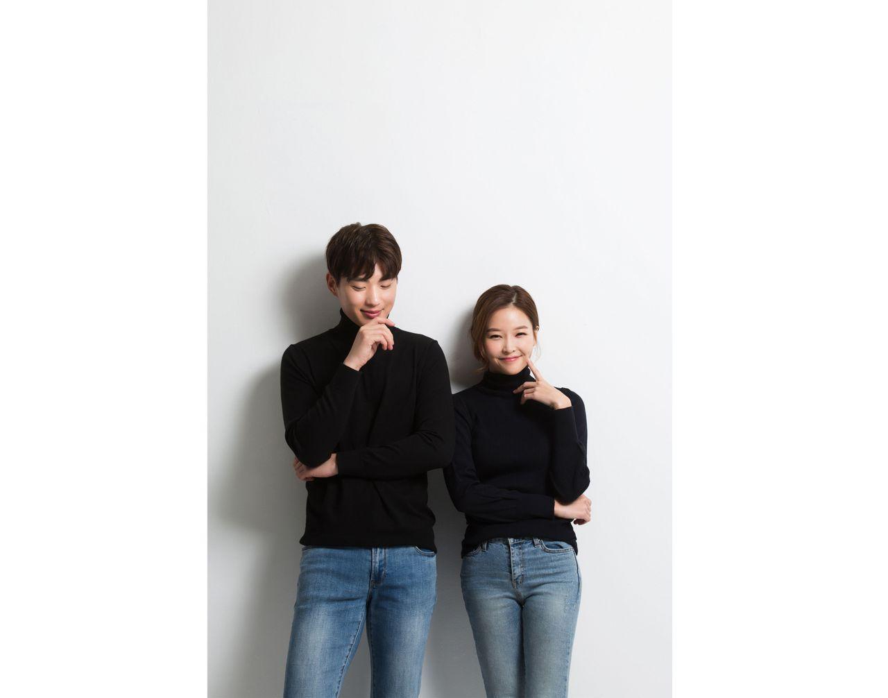 Engaged couple in matching casual jeans and tops, presenting a stylish and contemporary look.