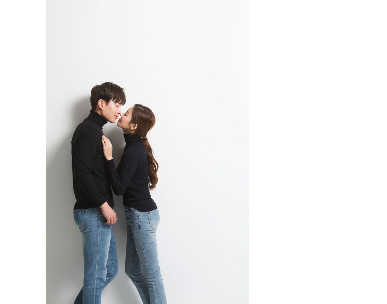 Fun and playful studio portrait with the couple dressed in contrasting outfits, showcasing versatility in poses.