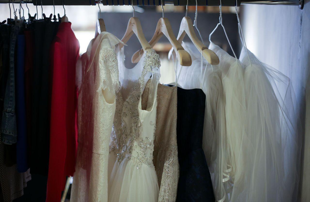 Close-up of beautiful bridal gowns, emphasizing the luxurious fabric and detailed craftsmanship.