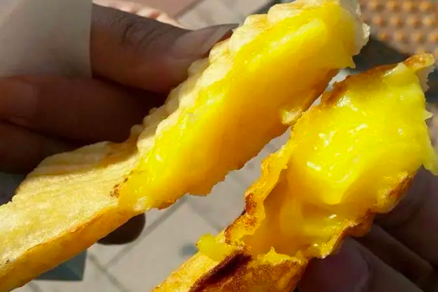 Bungeoppang, a Korean pastry, shown with creamy filling, highlighting the variation of this street food snack.