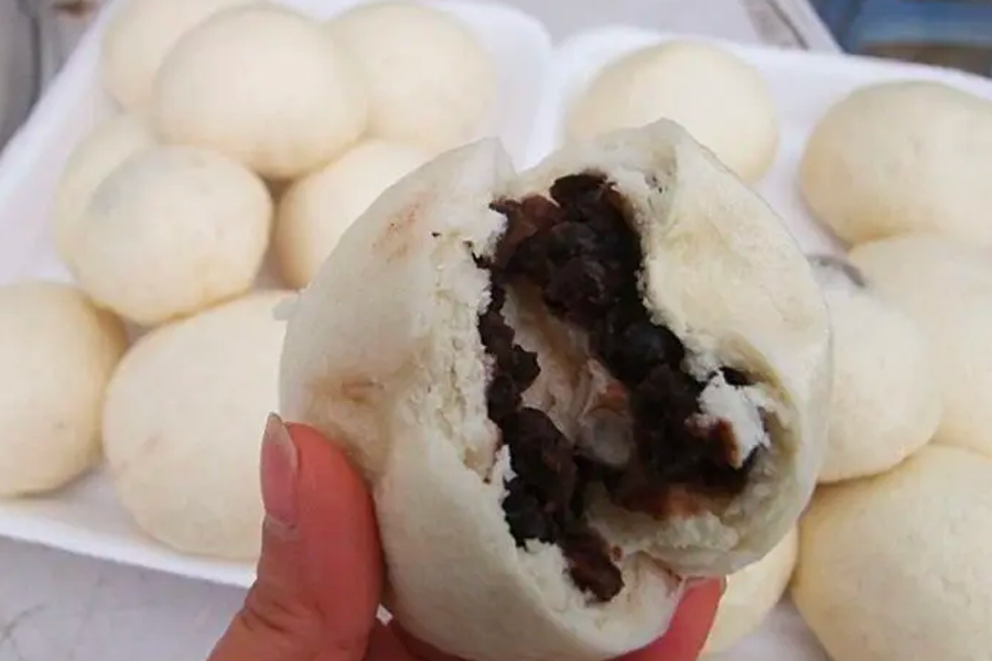 Korean steamed buns with sweet red bean filling, showcasing the soft and fluffy texture of these popular street snacks.