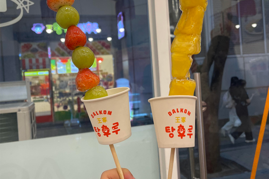 Close-up of assorted Korean Tanghulu candies on sticks, a trendy street food snack for MZ generation.