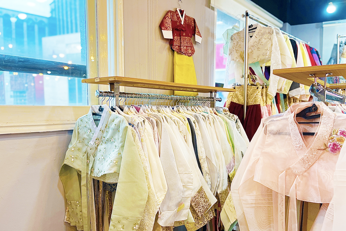 A tailor-designed hanbok featuring delicate embroidered flowers and a translucent overlay, illustrating the attention to detail and quality provided by Princess Hanbok.