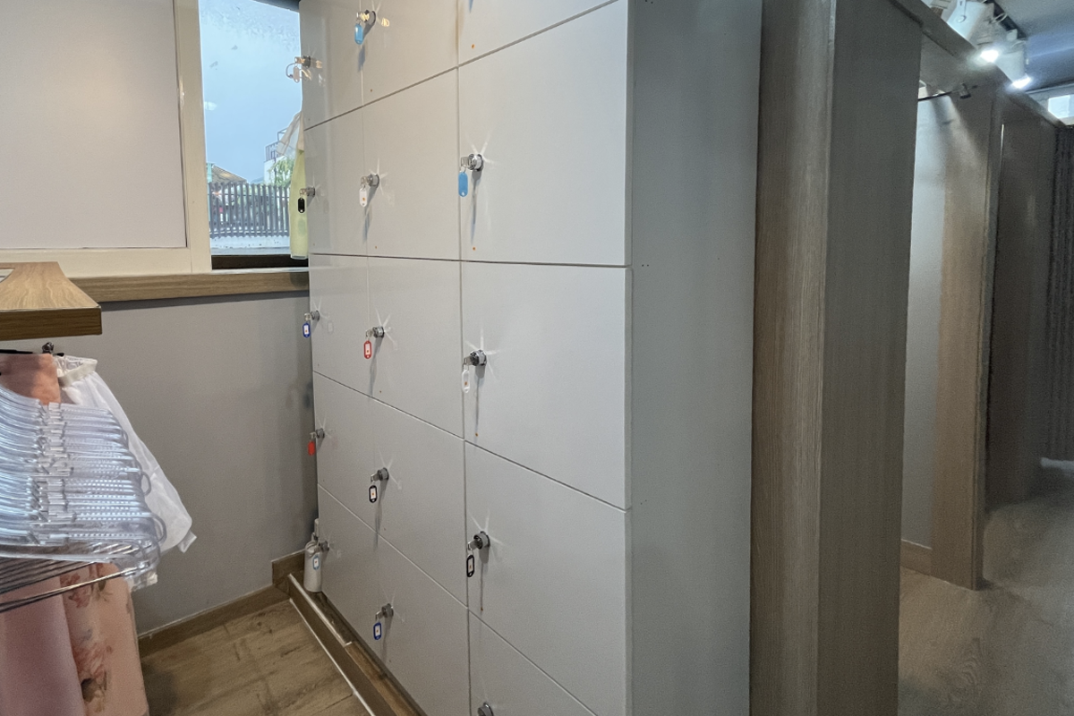 An assortment of hanboks with rich, ornate designs displayed inside Princess Hanbok store, appealing to tourists seeking to embrace Korean culture and tradition.