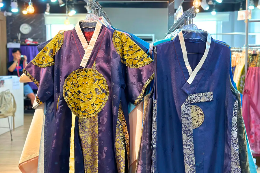 Interior view of Princess Hanbok rental, displaying an array of traditional Korean hanbok clothing on racks.