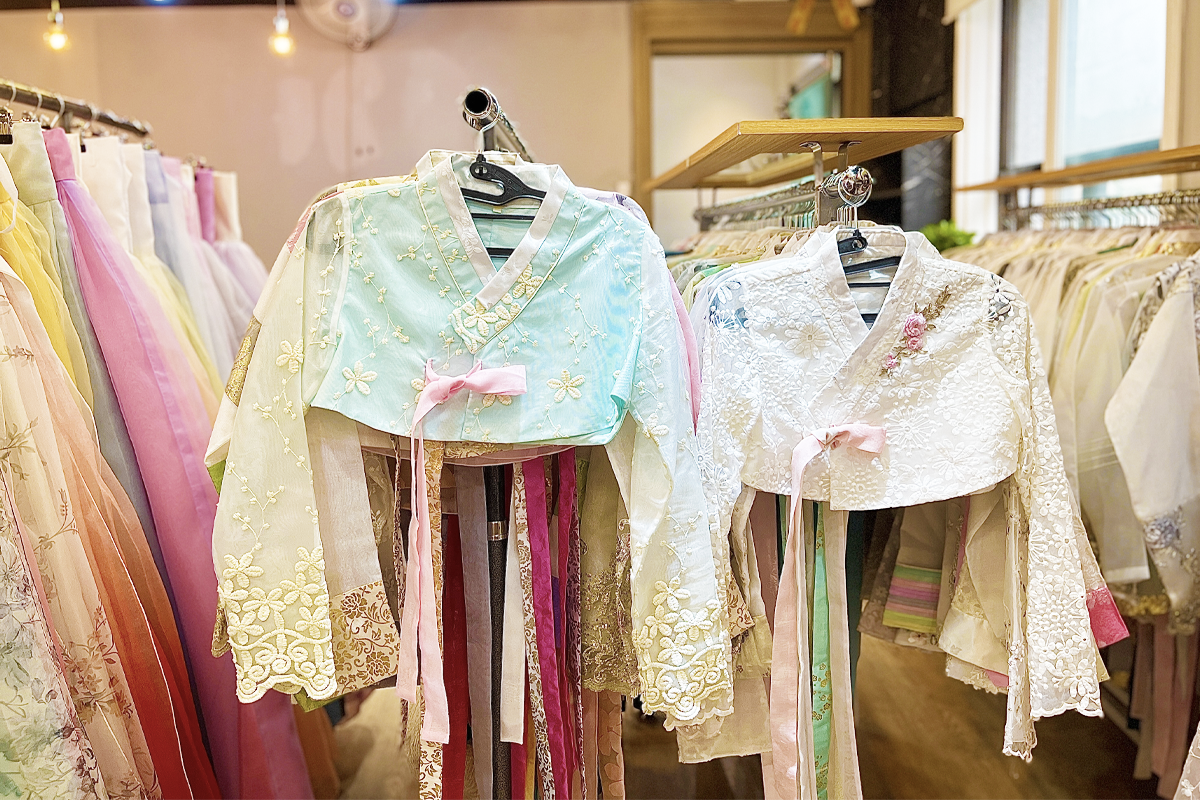 A display of bright and colorful hanboks with various designs, from elegant patterns to bold hues, suitable for blending tradition with style at Princess Hanbok rental store.