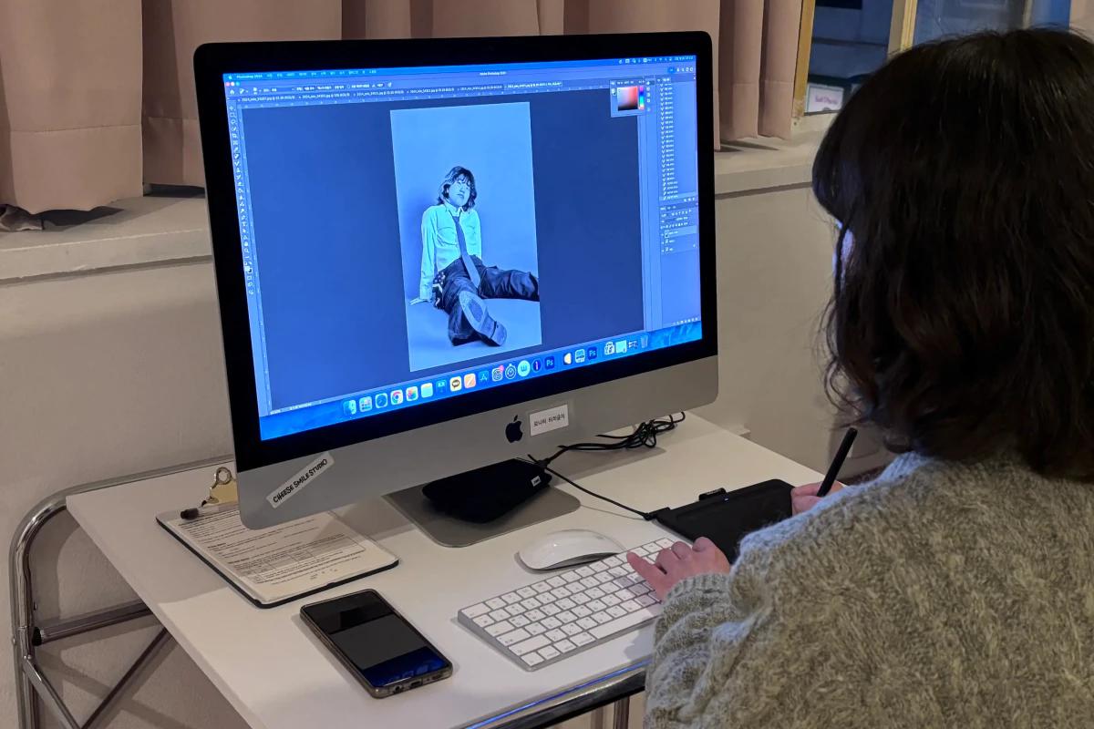 セルフポートレイトを撮影する人物。リモコンを使って写真を撮る様子。