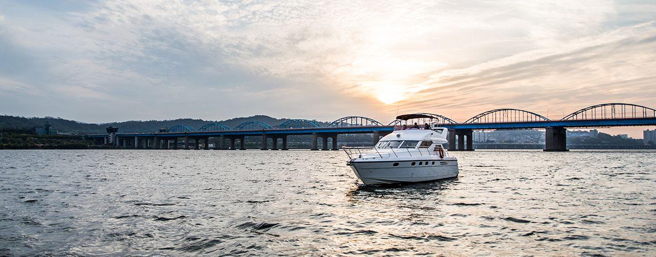 Chic and stylish interior of a luxury yacht offering a spacious lounging area with elegant decor on the Han River.