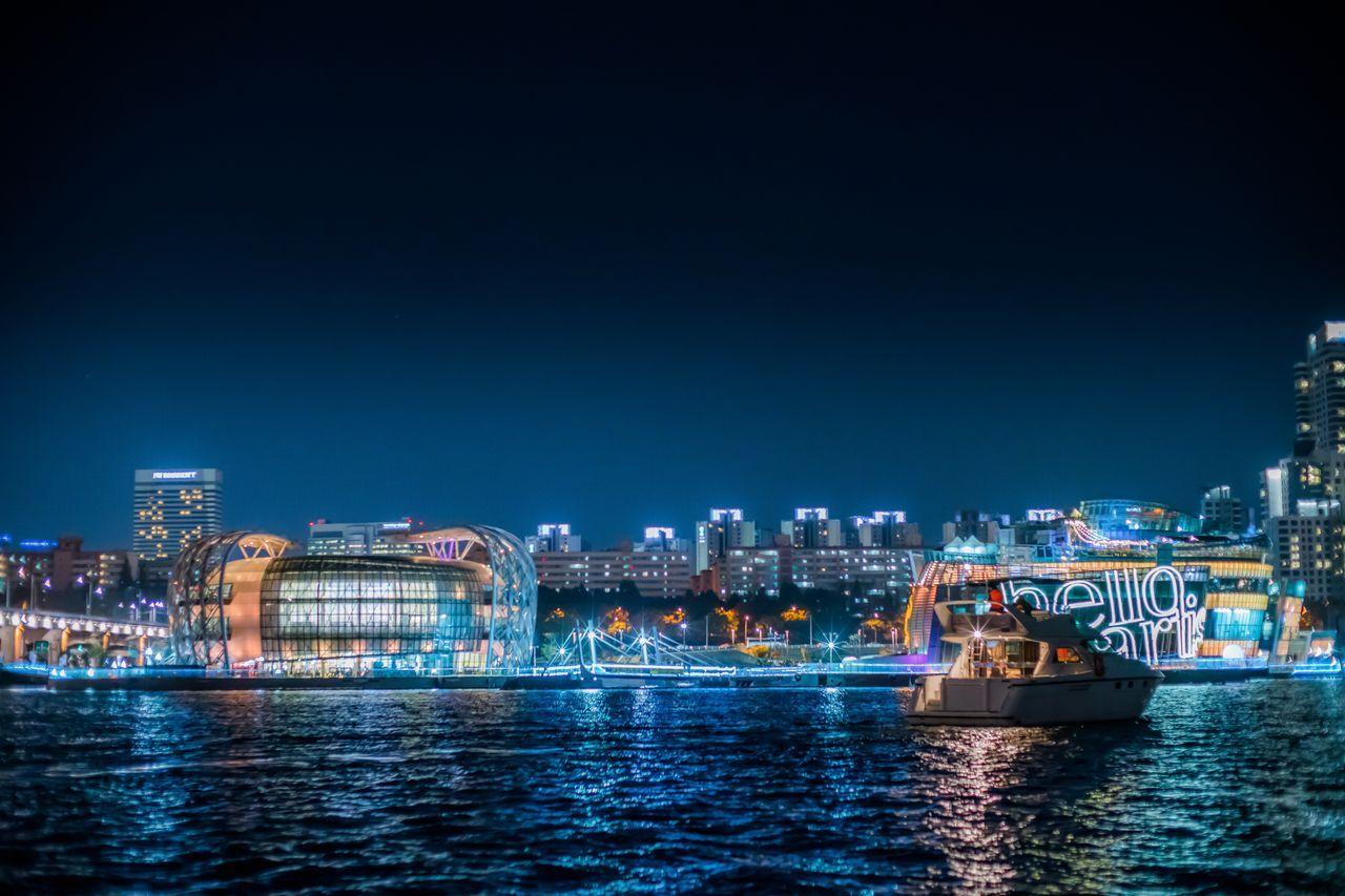 Golden Blue Marina at night showcasing a yacht cruising along the Han River, capturing the illuminated skyline of Seoul.