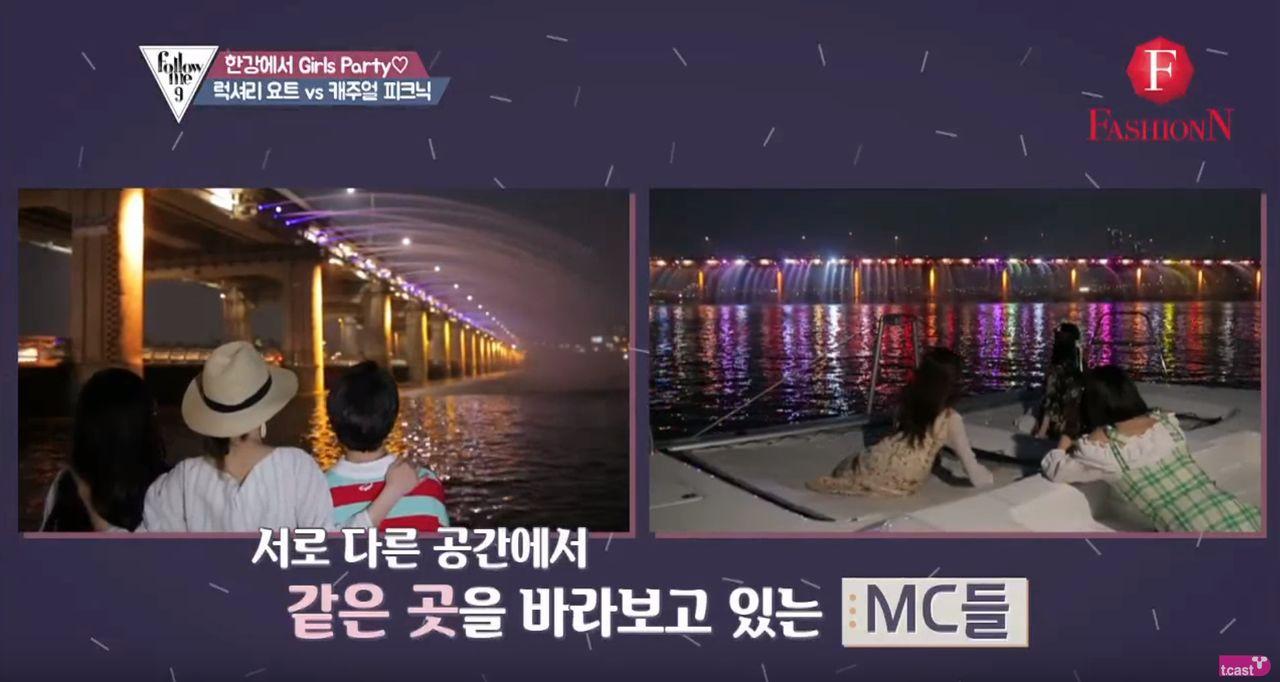Spectators on a yacht admiring Banpo Bridge's dazzling water fountain performance on the Han River at night.