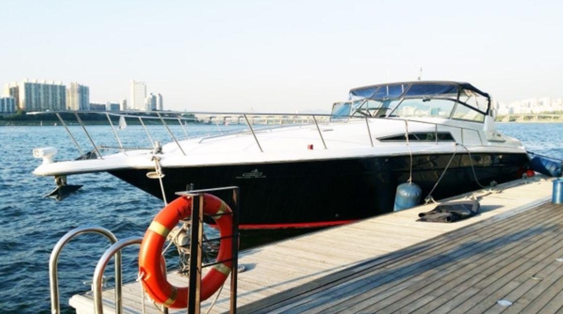 The sleek Sea-Ray Yacht docked at Han River, reflecting luxury with its polished design and modern amenities.