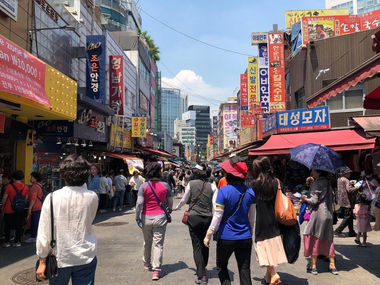 南大門市場的主要街道，人們在晴天中購物