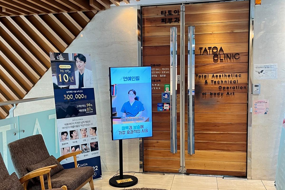 TATOAクリニックの入口を示す看板。サロンのロゴと木製の扉が特徴的です。