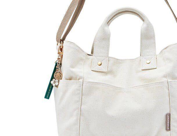 Ehwa store exclusive tote bag design in a natural setting with additional Starbucks products.