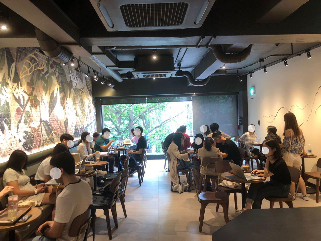 Modern interior of the Ehwa Starbucks store illustrating the community seated ambiance.