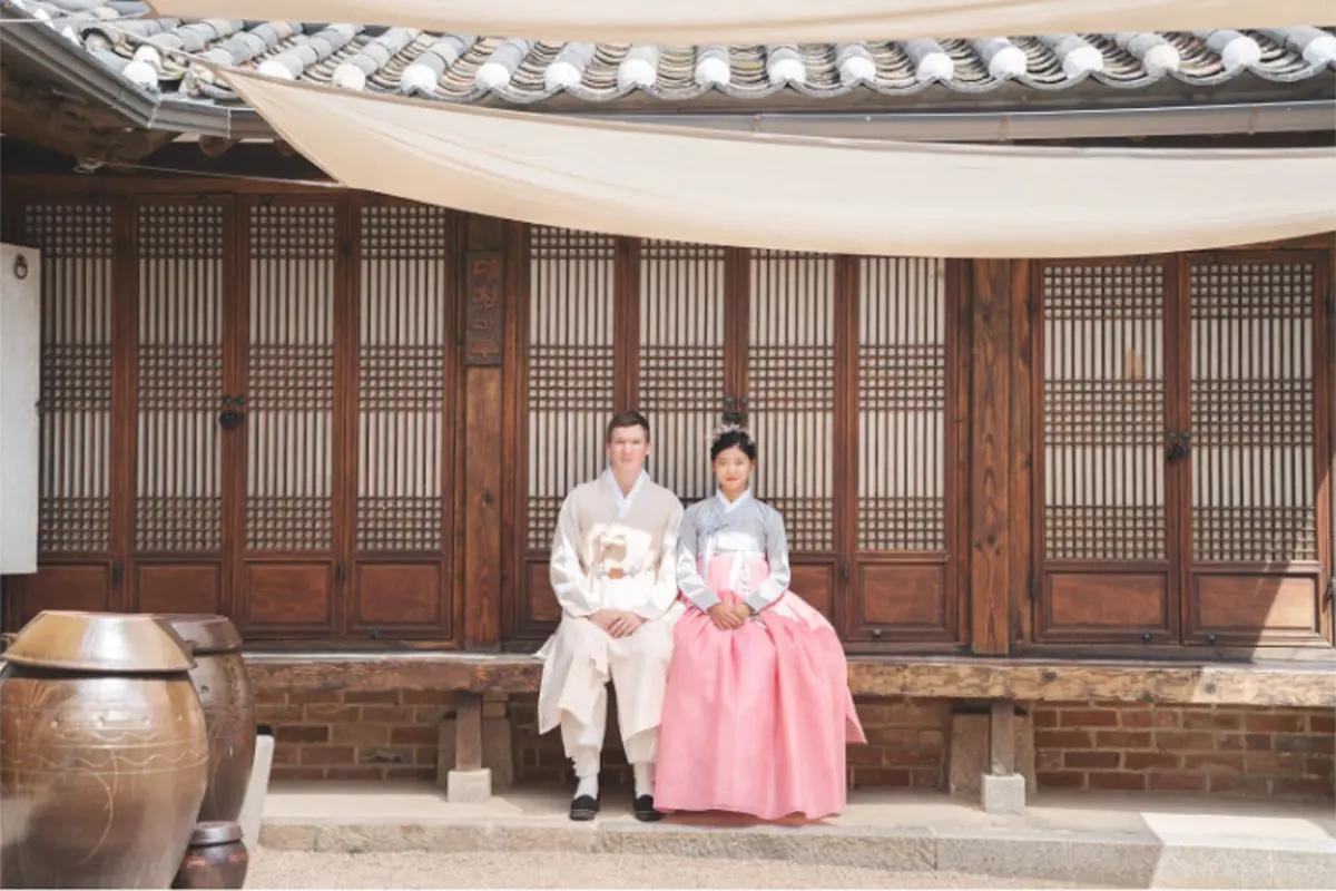Person in hanbok exploring the charming lanes of Bukchon Hanok Village.