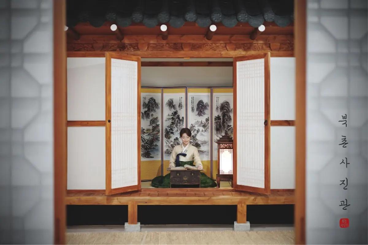 Hanbok photoshoot at Bukchon Hanok Village with traditional Korean architecture in the background.