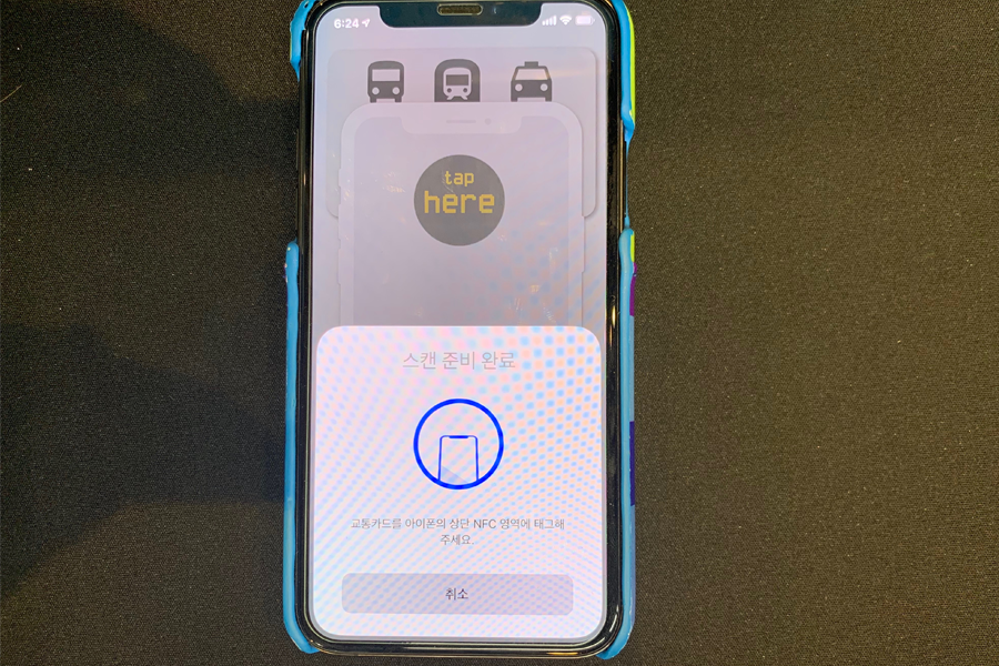 韓國交通卡查詢應用程序的感應畫面展示，顯示“Tap here”字樣的使用方法示意圖。