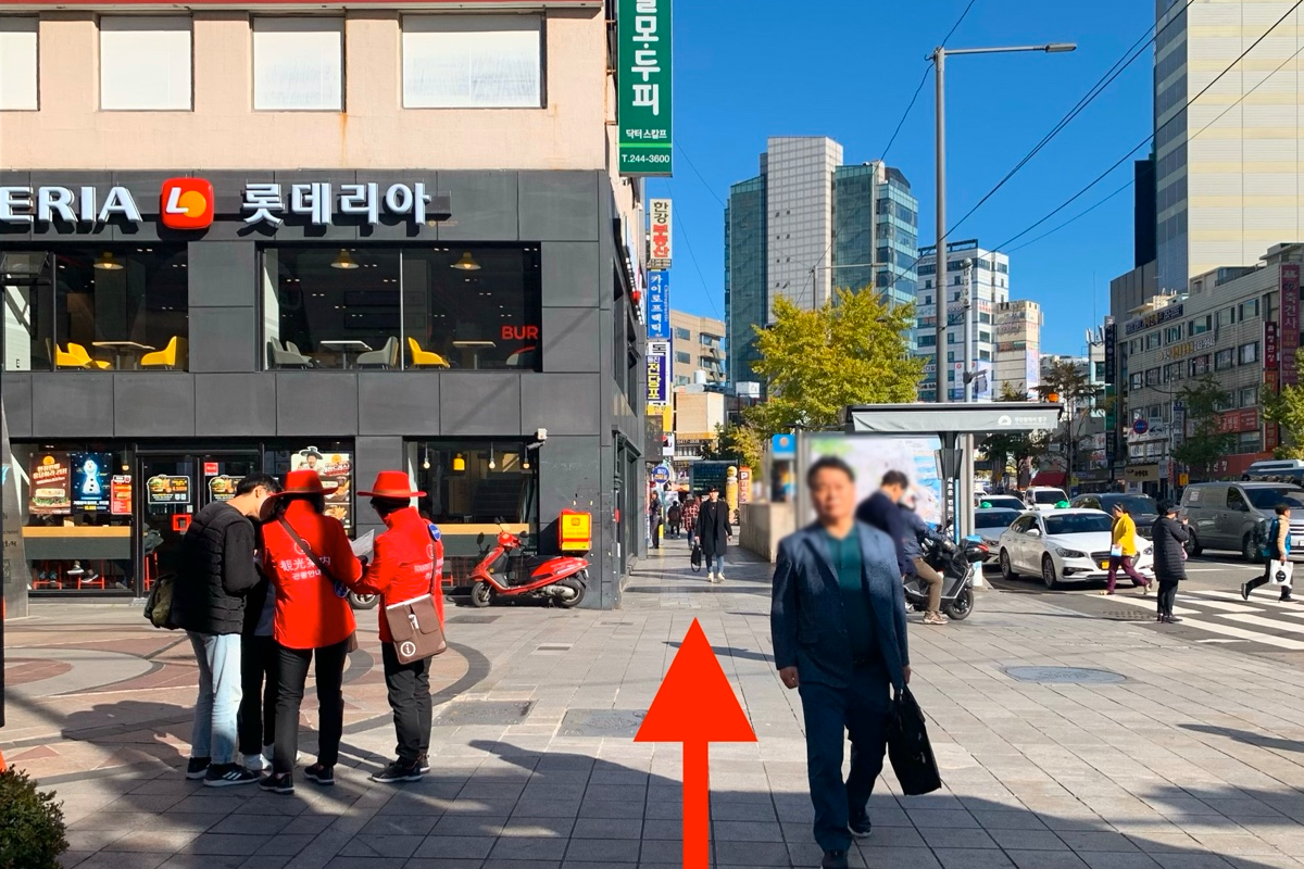 釜山南浦洞街道景色，展示Loteria餐廳和行人步道，旁邊有數輛車停泊。