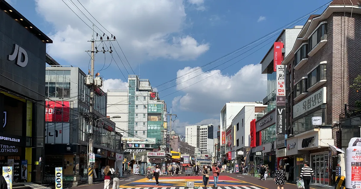 首爾的現代化街景，展示著清新的城市氛圍，店鋪林立，是生活與商業活力的象徵，吸引著當地人與遊客。
