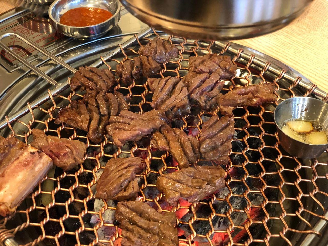 五道麵屋で焼かれるカルビ肉。一口サイズにカットされ、グリルの上でちょうど良く焼かれている。