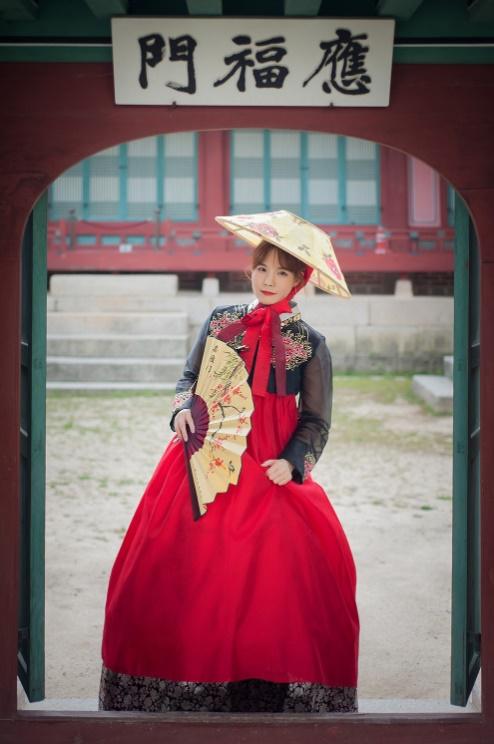 緑の草原で韓服を着た二人の女性が楽しそうに寝そべる姿