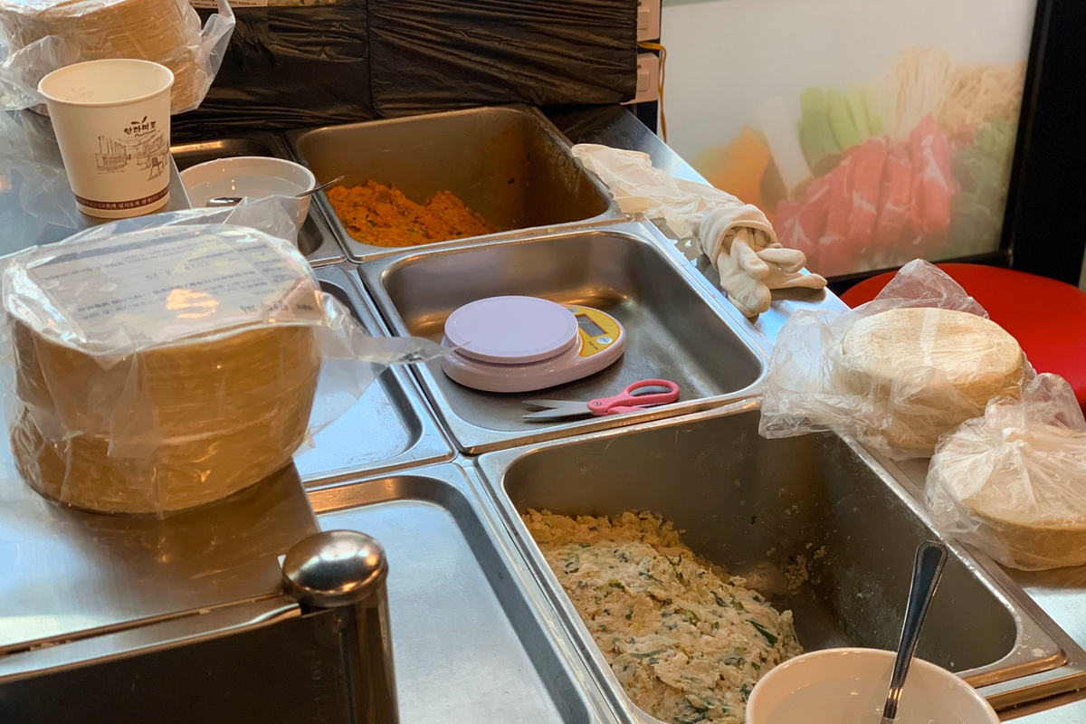 聖經餃子店內部標識，光線從窗外照進室內，使手工餃子專賣店顯得温馨舒適。