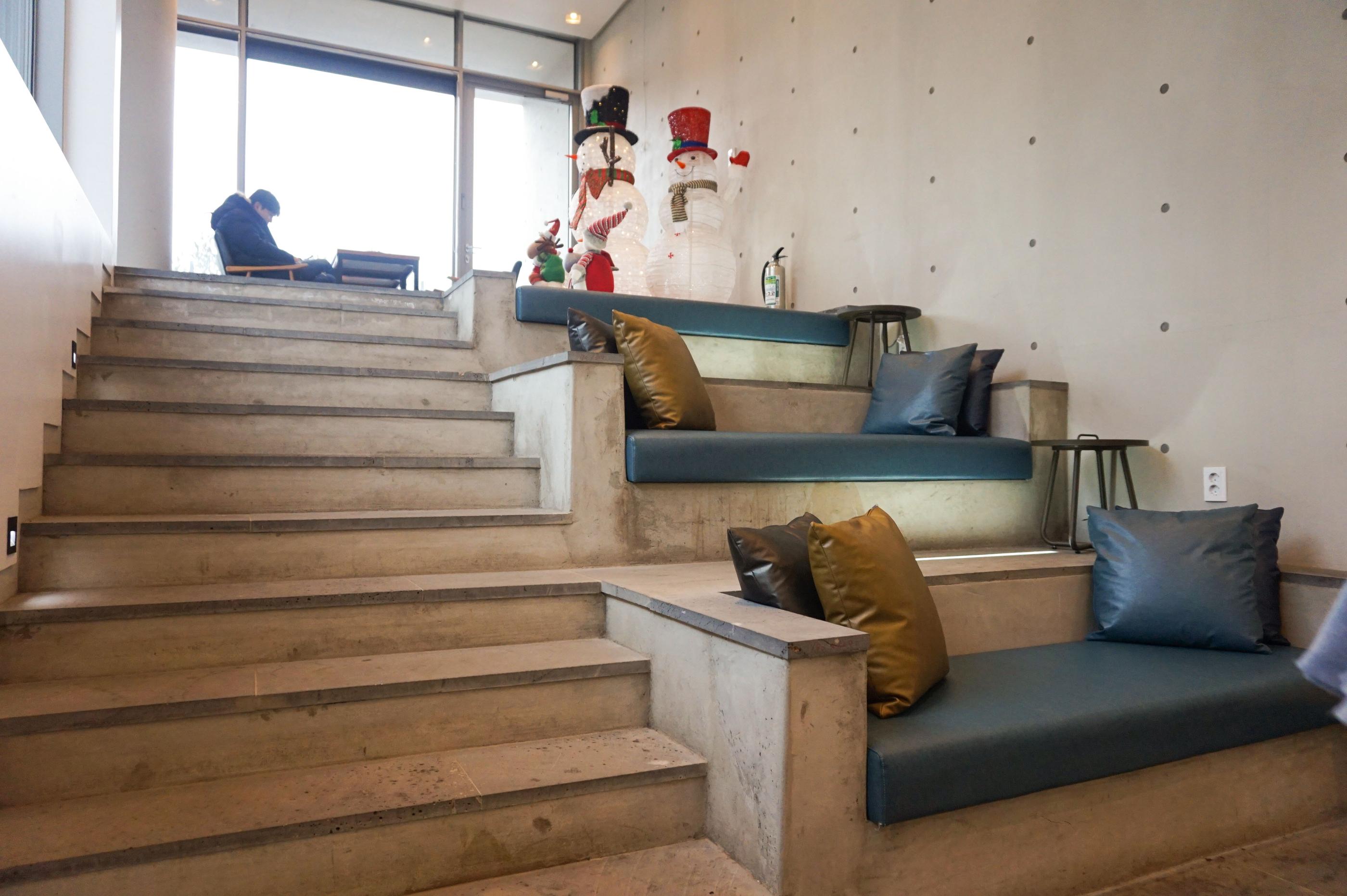 Modernes interiordesign im GARDENUS Café mit gemütlichen Sitzecken und minimalistischer Ästhetik.