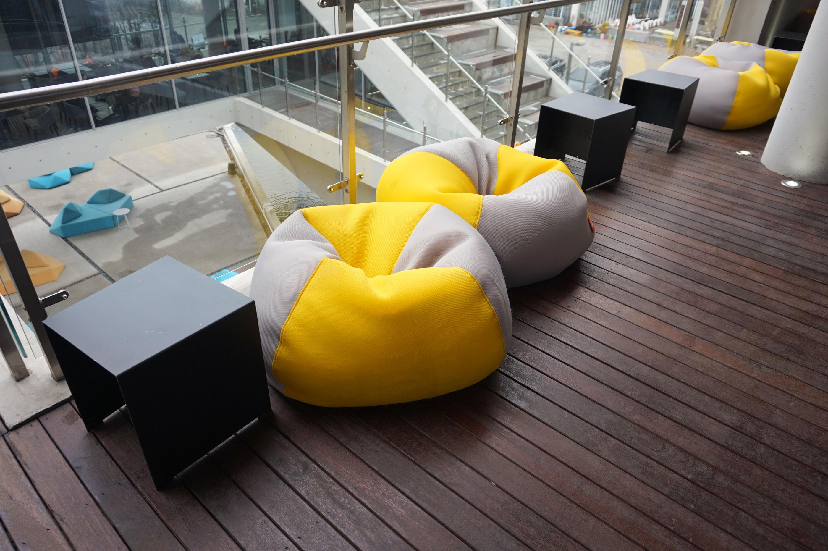 Verschiedenfarbige Sitzsäcke auf der Terrasse des GARDENUS Cafés in Paju.