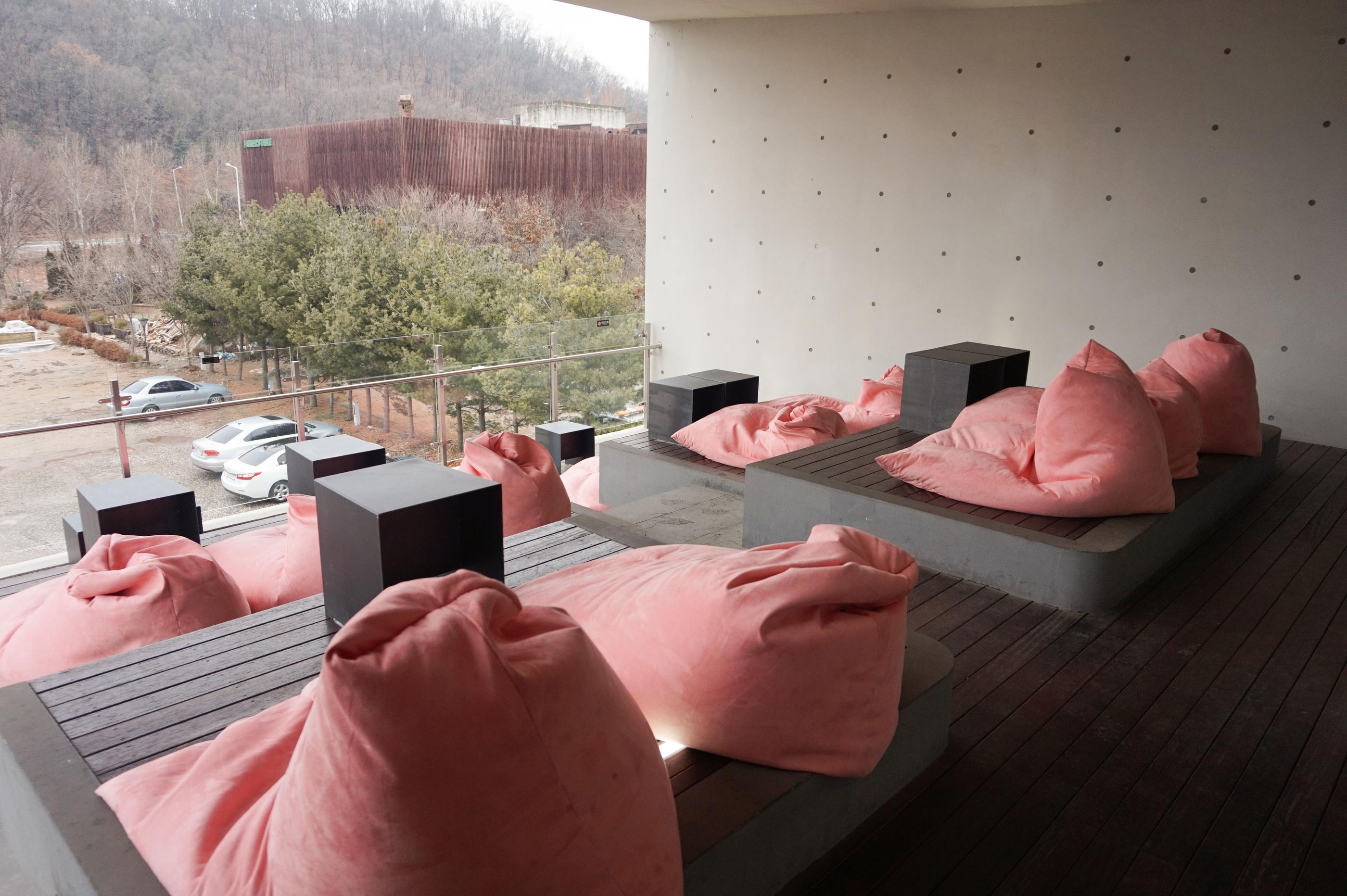 Entspannende Sitzecken auf der Außenterrasse des GARDENUS Cafés in Paju.