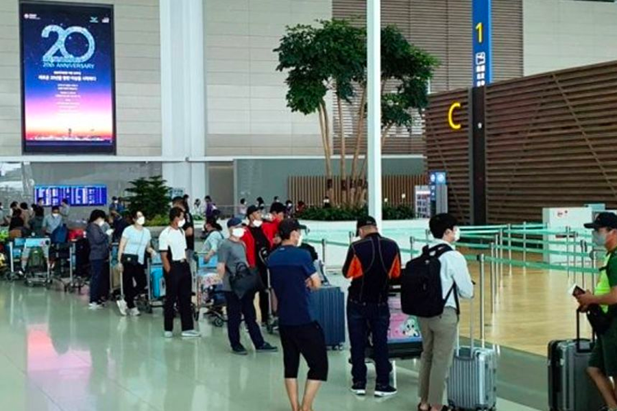 仁川國際機場內部，旅客因疫情防控措施進行檢查及排隊等候過程。