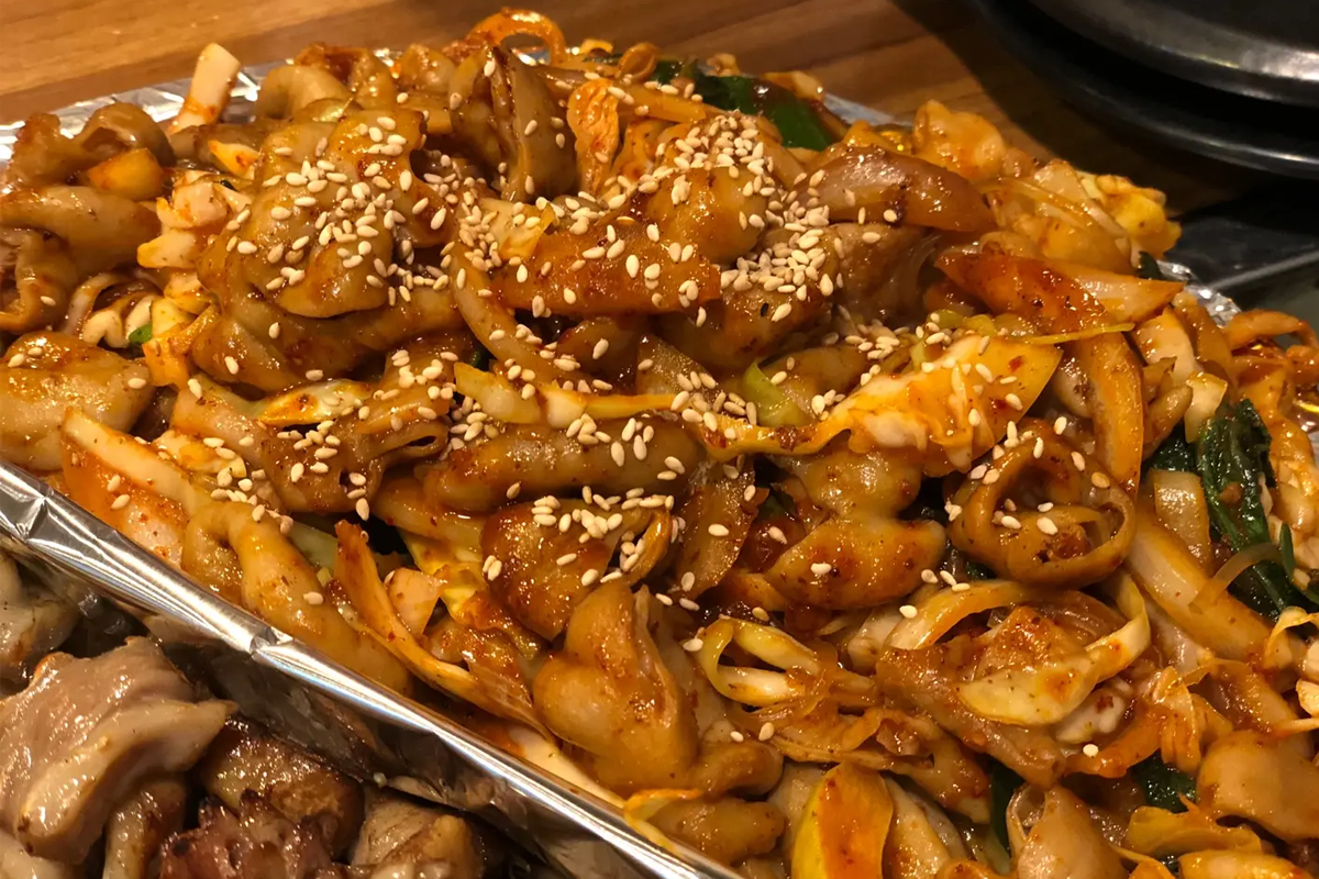 擺放於盤中的辛辣蔬菜小腸，上面撒著炒香的白芝麻，富有層次的口感是在Jungbu家不可錯過的選擇。