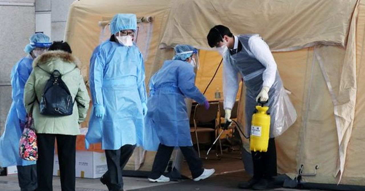 醫護人員在帳棚式檢驗空間進行消毒作業。