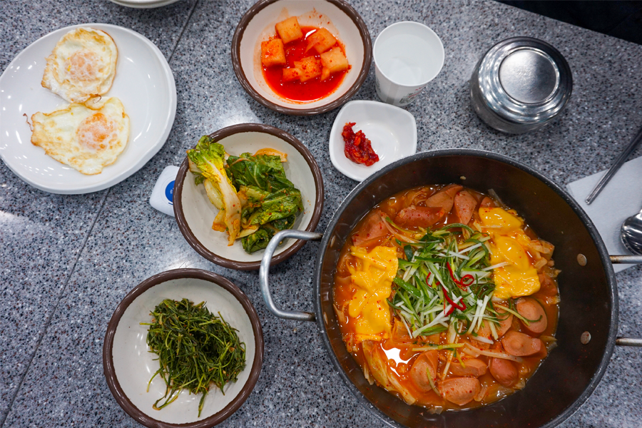 大海食堂的韩式部队锅，呈现着丰富的配料和芝士，散发诱人香味。