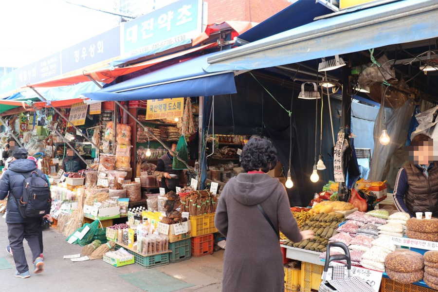 藥令市場中的韓國人參商店，琳瑯滿目的藥材和顧客間的交流