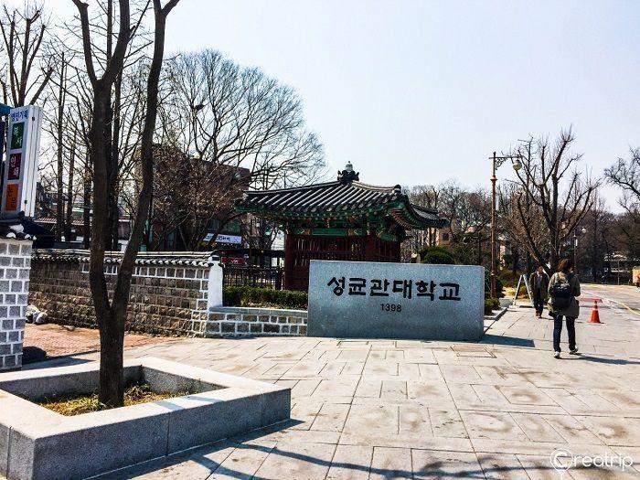 韩国首尔成均馆大学入口标志，校园一角的春日景色展示了校园的开放与悠久历史。