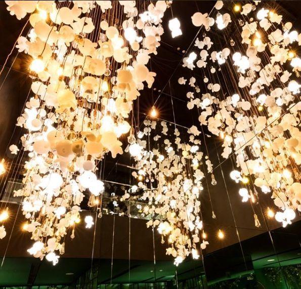 Bright lighting installation featuring Kakao Friends shapes at an exhibition.