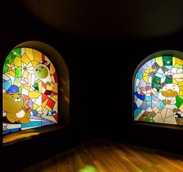 Colorful stained glass display panel showcasing Kakao Friends characters in a whimsical scene.