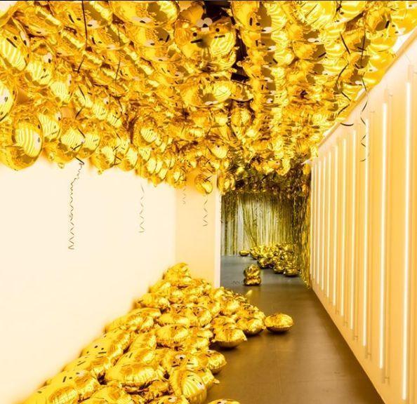 Decorative golden Ryan balloons filling an interactive photo space in the museum.