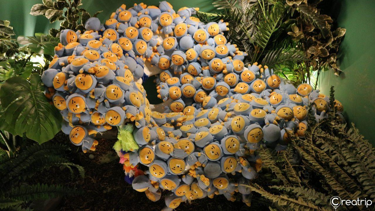 Decorative setup of plushies depicting Kakao Friends characters arranged in a large circular display.