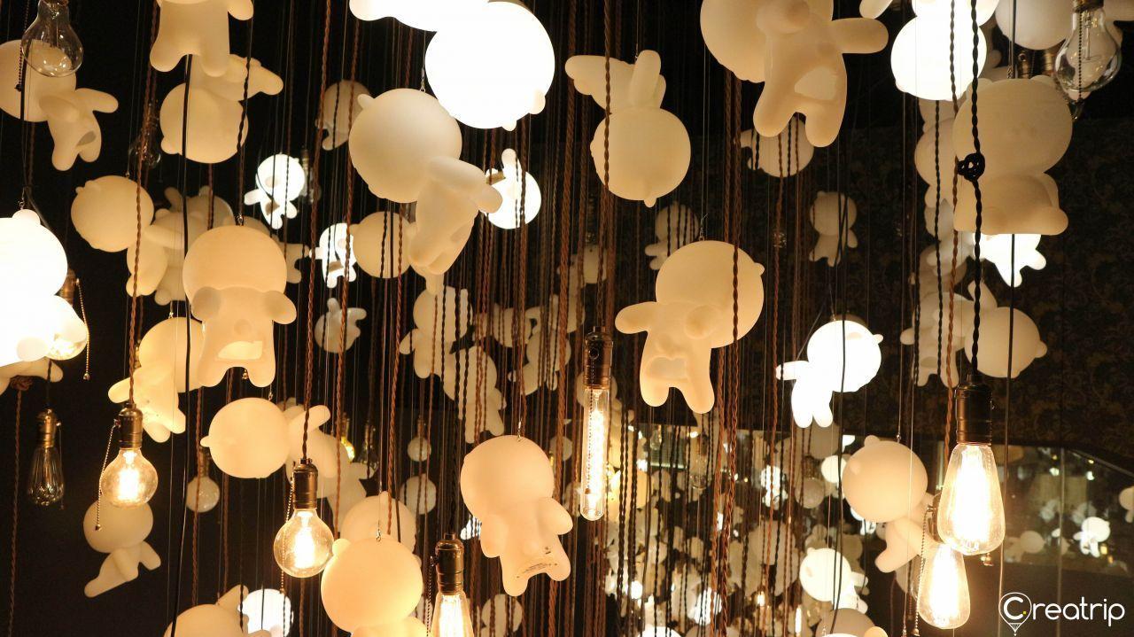 Artistic hanging display of Kakao Friends figures with ambient lighting inside the museum.
