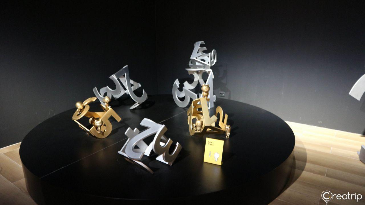 Close-up of a Kakao Friends glass sphere art piece set on a decorative pedestal.