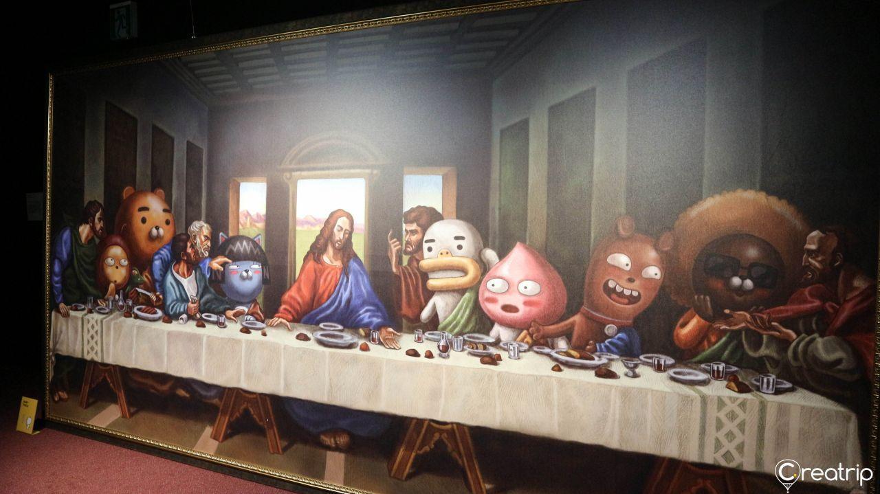 Art gallery with Kakao Friends portraits in elaborate gold frames hanging from the ceiling.