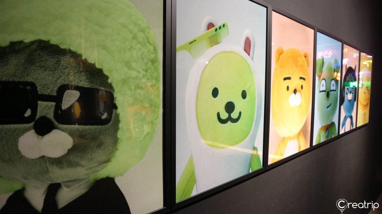 Sketches and drafts of editorials with Kakao Friends influence on display.