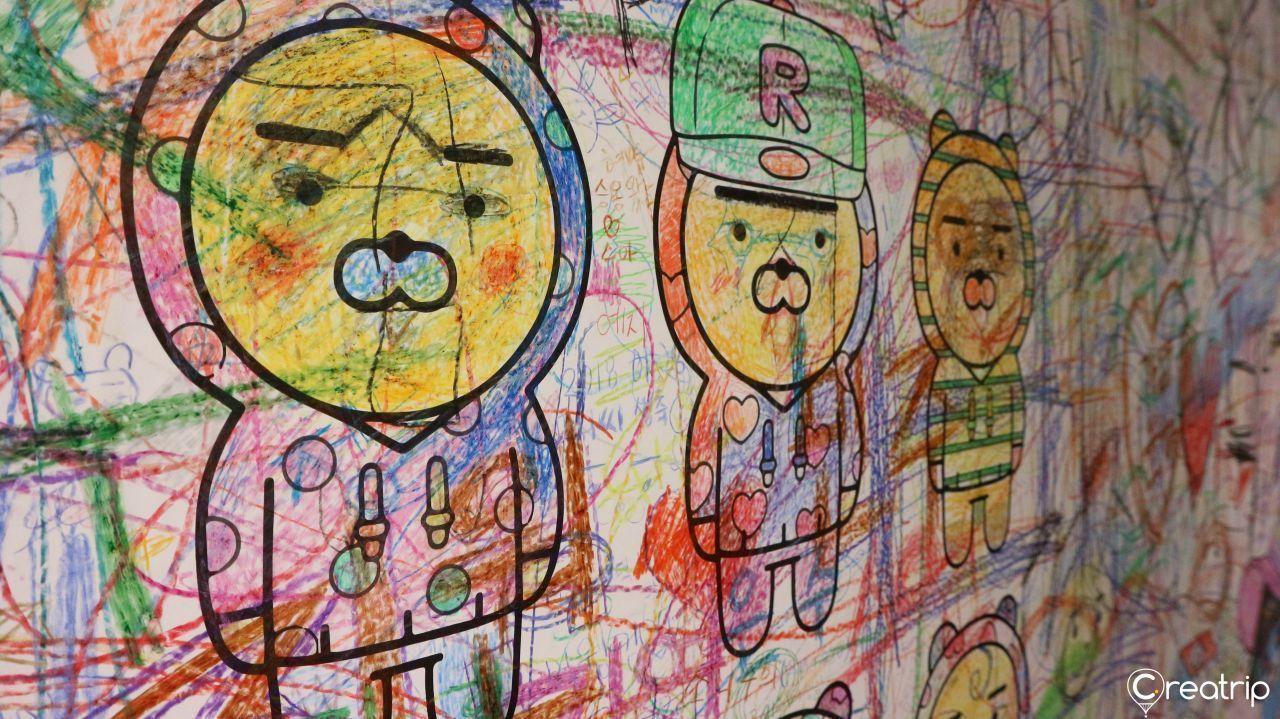 Merchandise exclusive to Kakao Friends Museum, including sweaters and mugs.