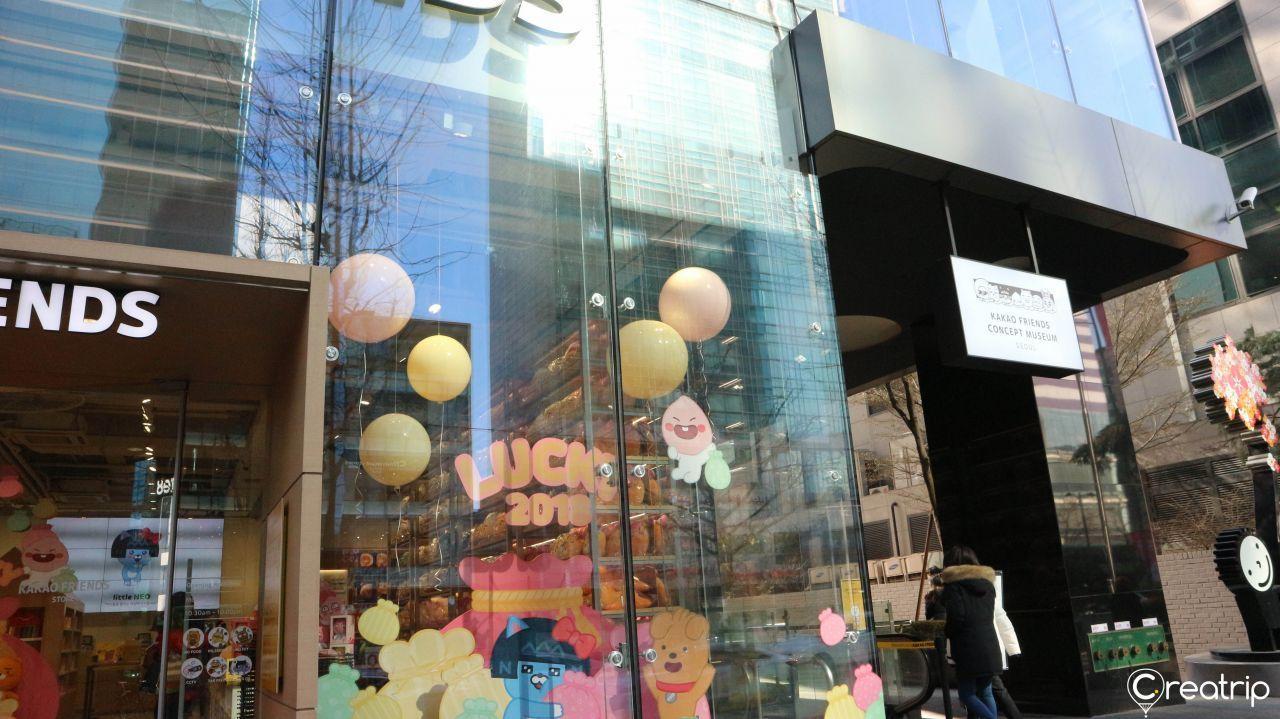 Exterior of Kakao Friends Store with colorful decals depicting Kakao Friends characters.