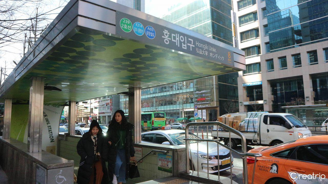 Exit 8 of Hongdae Station with signage and surrounding buildings in Seoul.