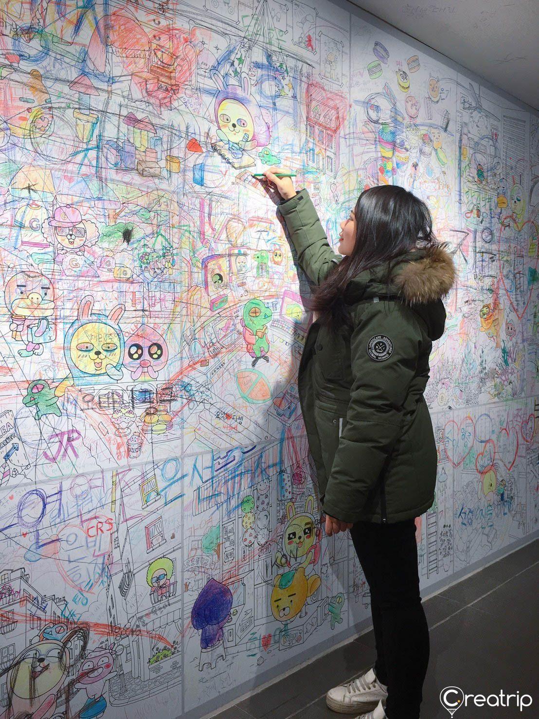 Wall full of visitor signatures and drawings at Kakao Friends interactive corner.