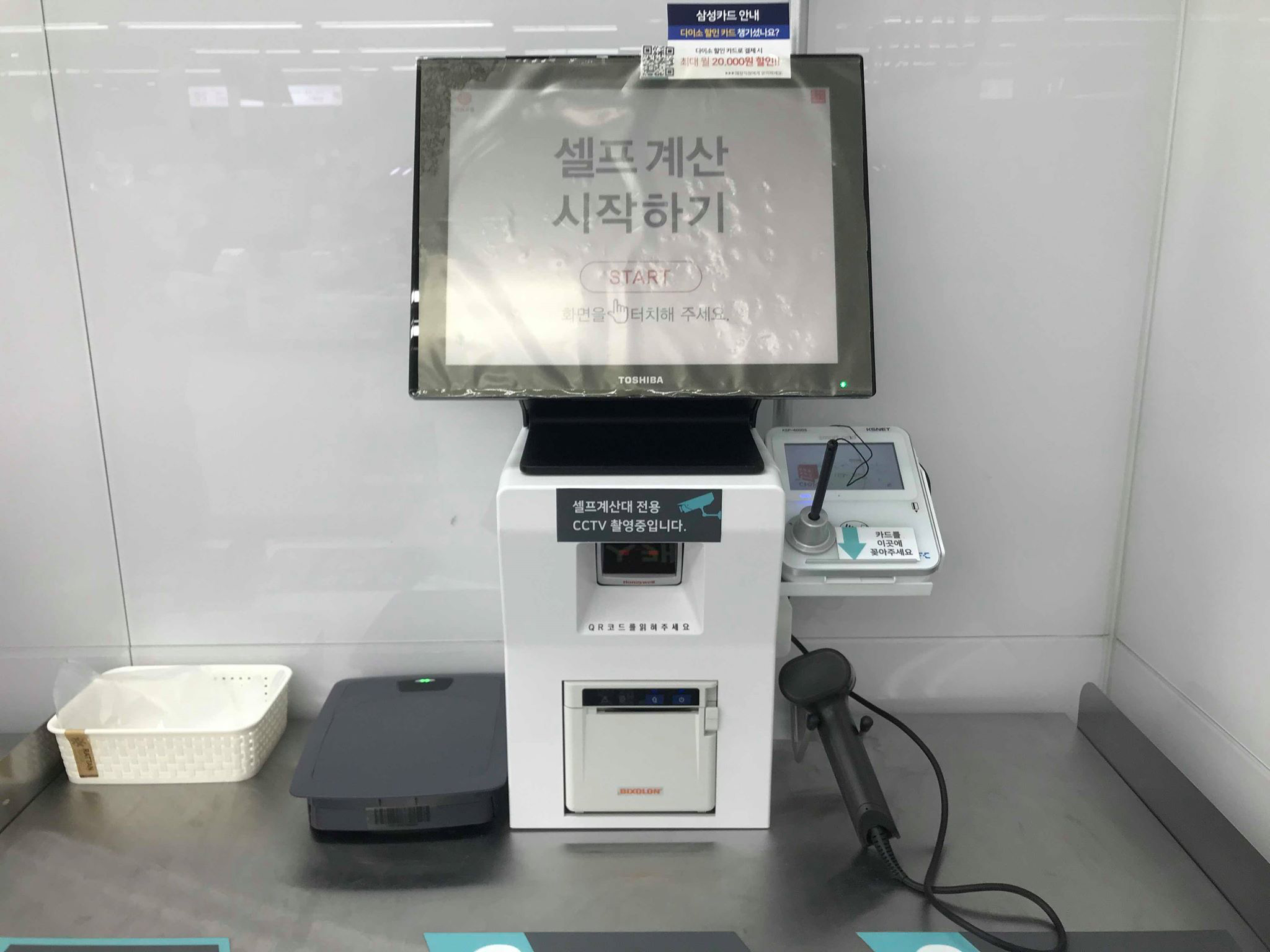 เครื่องจ่ายเงินอัตโนมัติในร้านไดโซะในเกาหลี แสดงหน้าจอทัชสกรีนพร้อมตัวเลือกเริ่มต้นที่เขียนว่า 'START' ภาษาอังกฤษและภาษาเกาหลีสำหรับการเริ่มต้นการใช้งานเครื่องจ่ายเงินอัตโนมัติ